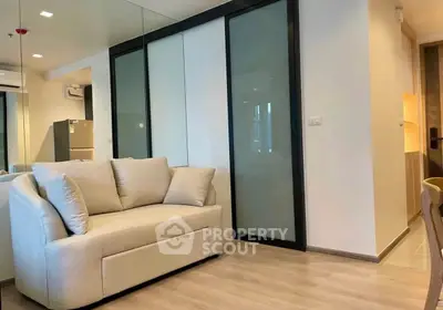 Modern living room with sleek sliding doors and cozy beige sofa.