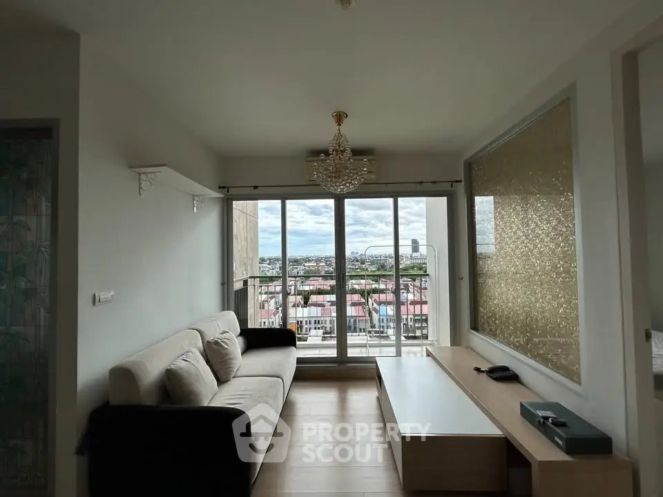 Spacious living room with stunning city view and elegant chandelier