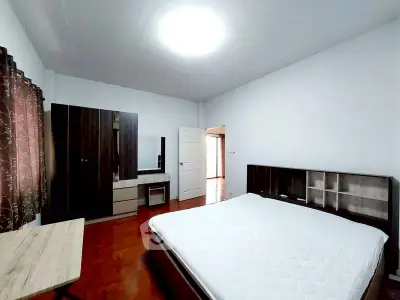 Spacious bedroom with modern furniture and ample natural light
