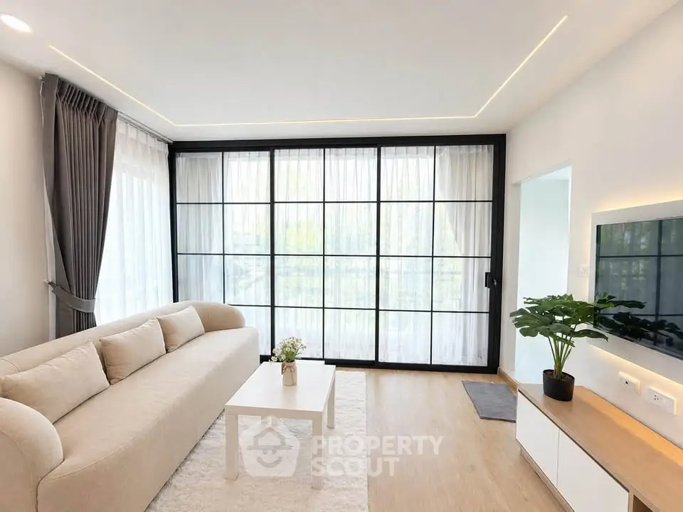 Modern living room with large windows and stylish decor