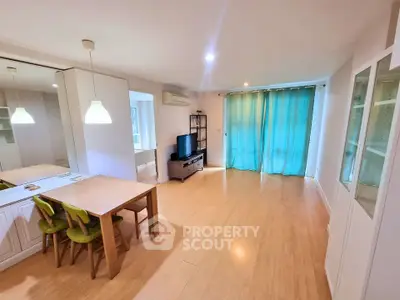 Spacious modern living room with wooden flooring and stylish furniture