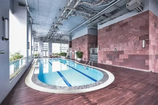 Luxurious indoor pool with modern design and city view, perfect for relaxation and leisure.
