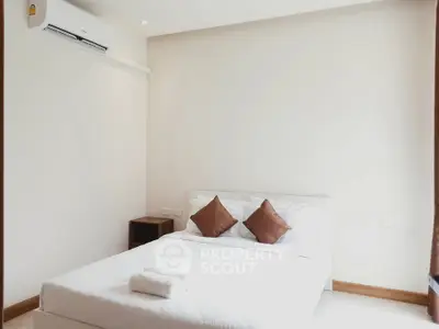 Bright and cozy bedroom with minimalist decor and air conditioning