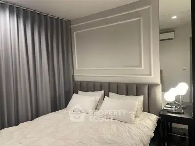 Elegant bedroom with plush bedding and modern lighting