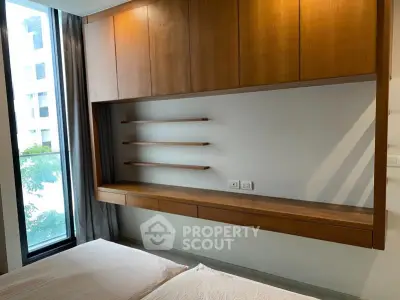 Modern bedroom with built-in wooden shelves and large window view