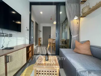 Modern living room with stylish decor and open view to dining area