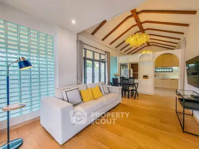 Spacious living room with vaulted ceiling and modern kitchen in open layout