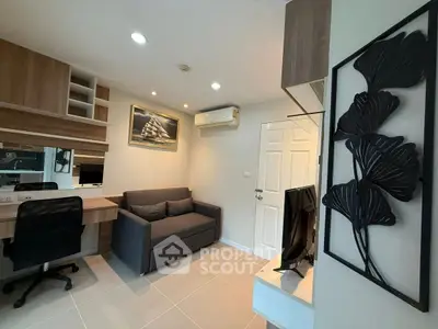 Modern living room with sleek furniture and wall art, featuring a cozy sofa and stylish decor.