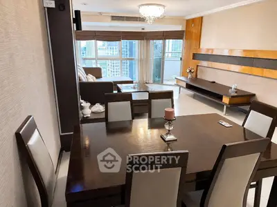 Spacious living room with elegant dining area and city view, featuring modern furniture and stylish decor.