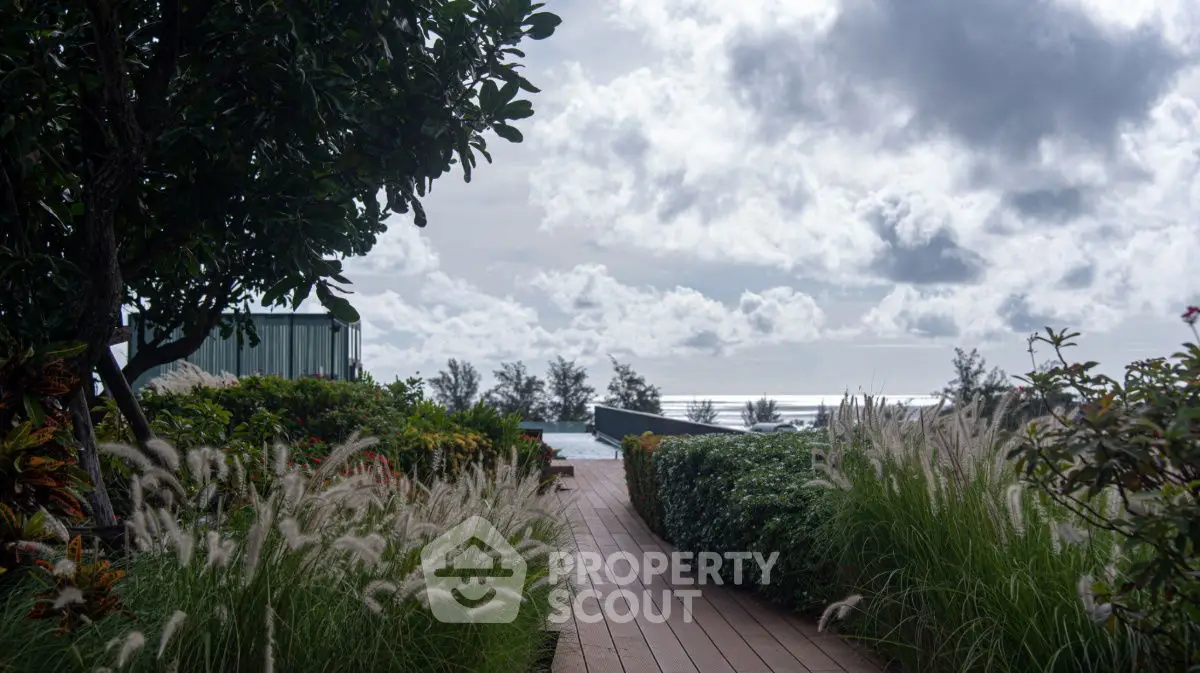 Stunning garden pathway leading to a serene pool with ocean view.