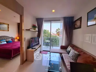 Charming living room with balcony access and cozy bedroom view in modern apartment.
