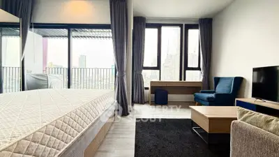 Spacious modern bedroom with city view and balcony access