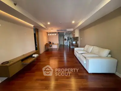 Spacious modern living room with wooden flooring and elegant white sofa