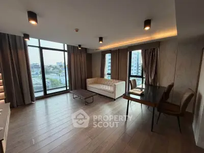 Spacious modern living room with large windows and city view