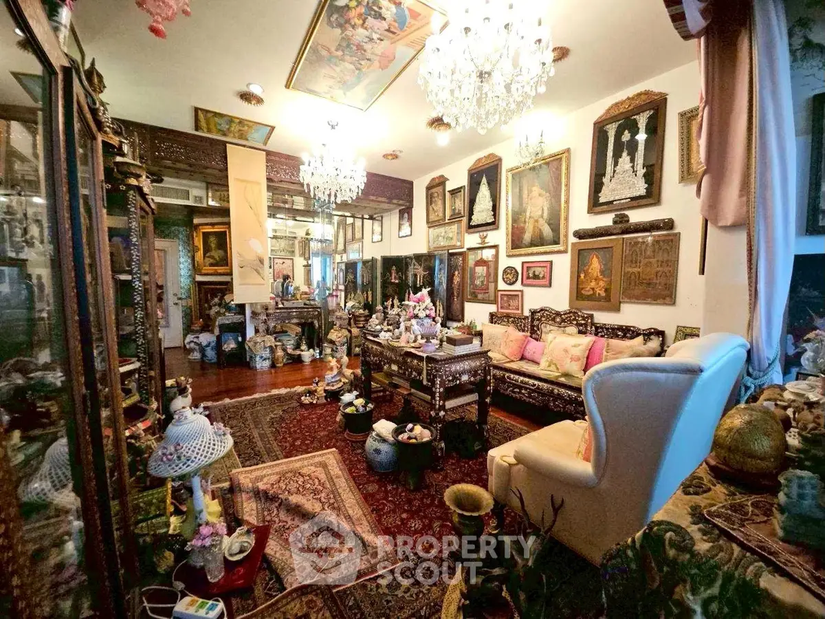 Luxurious living room with ornate decor, chandeliers, and antique furniture creating an opulent ambiance.