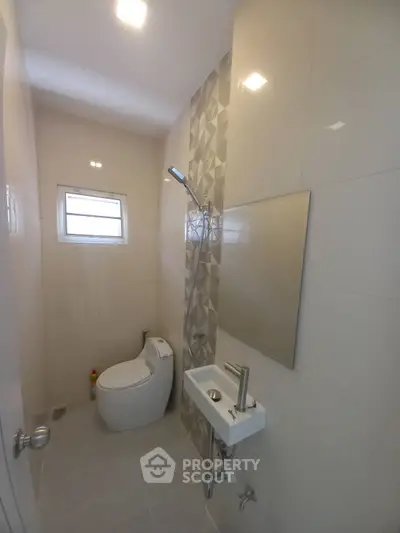 Modern compact bathroom with sleek fixtures and stylish tile design.