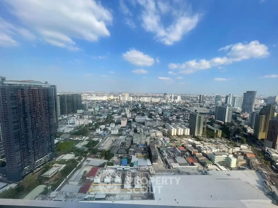 Stunning cityscape view from a high-rise building showcasing urban skyline under a clear blue sky.