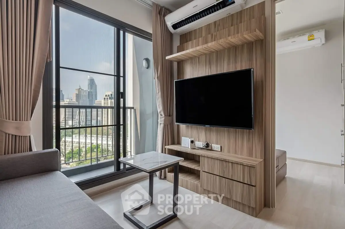 Modern living room with city view, sleek furniture, and large TV setup.