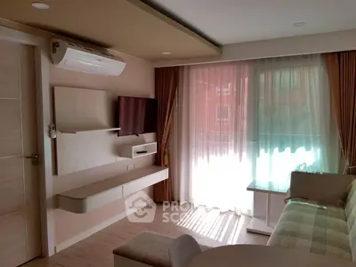 Modern living room with stylish decor and natural light, featuring a wall-mounted TV and air conditioning.