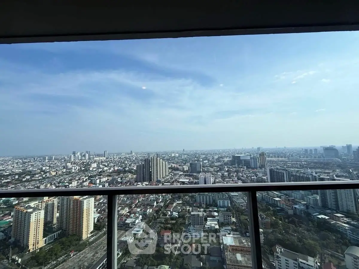 Stunning cityscape view from high-rise balcony showcasing urban skyline and expansive horizon.