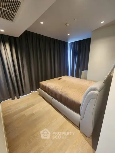 Modern bedroom with elegant curtains and cozy bed in a stylish apartment