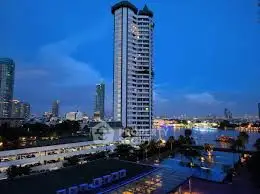 Stunning riverside high-rise building with cityscape view at dusk