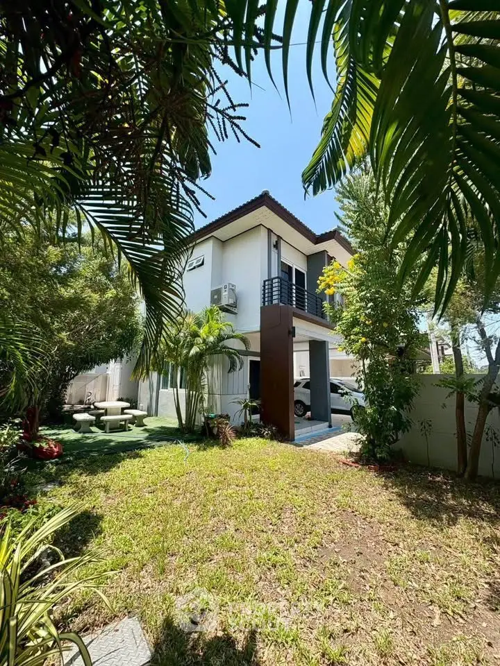 Charming two-story house with lush garden and modern design, perfect for family living.