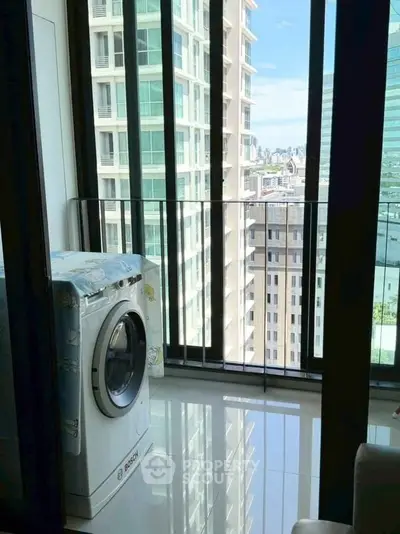 Modern apartment balcony with washing machine and city view