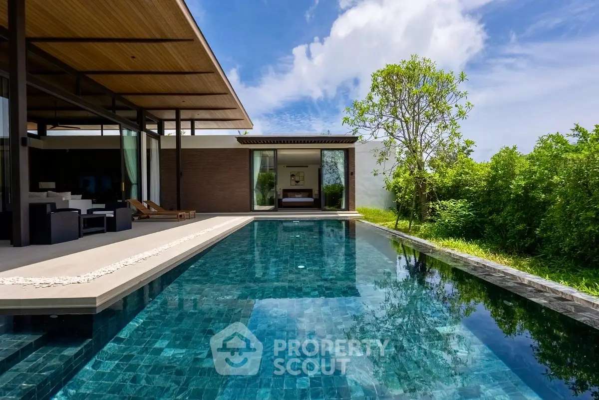 Luxurious modern villa with stunning pool and lush greenery, perfect for serene living.