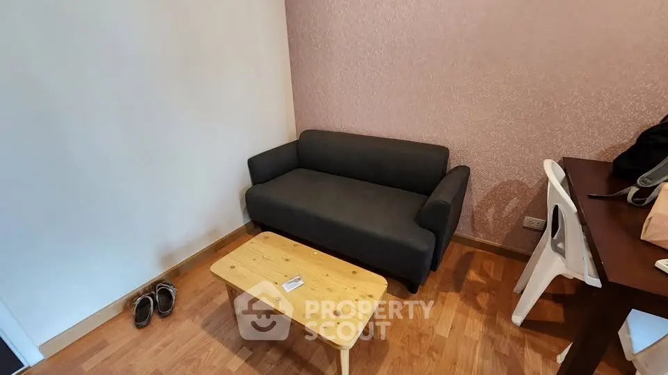 Cozy living room with modern sofa and wooden coffee table, perfect for relaxation.