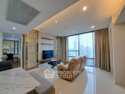 Spacious modern living room with city view, featuring elegant furniture and large windows.