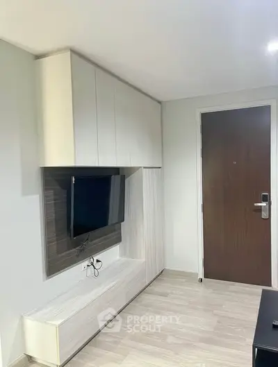 Modern living room with sleek TV unit and wooden flooring