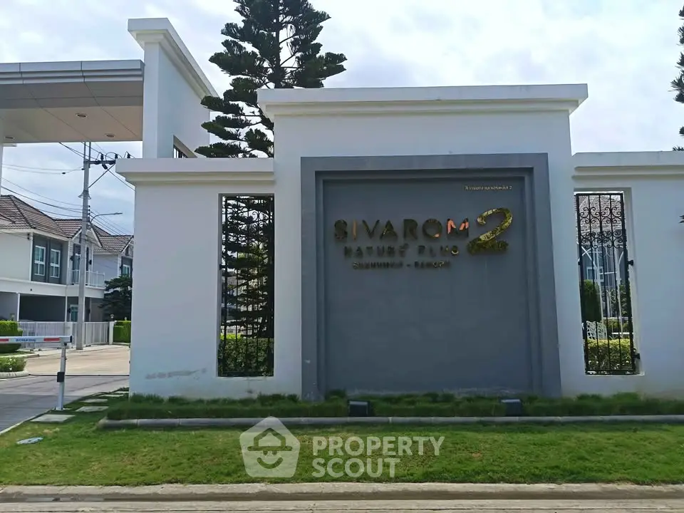 Elegant entrance of Sivaron Nature Plus residential community with modern architecture and lush greenery.
