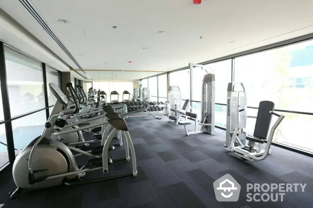 Spacious modern gym with state-of-the-art fitness equipment and panoramic windows