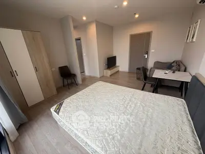 Modern bedroom with minimalist decor and cozy seating area