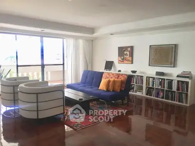 Spacious living room with modern furniture and large windows offering natural light.