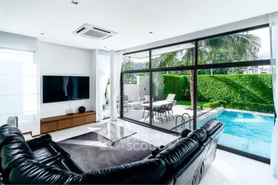Luxurious living room with pool view and modern leather sofa