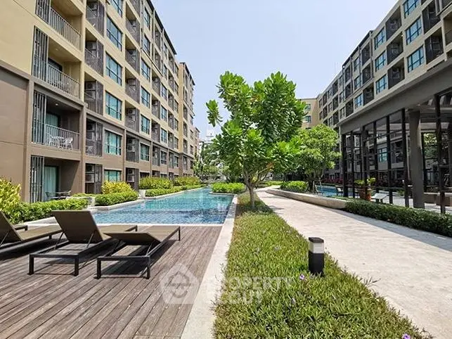 Modern apartment complex with pool and lush greenery, perfect for urban living.