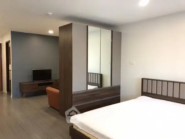 Spacious modern bedroom with sleek wooden furniture and cozy ambiance