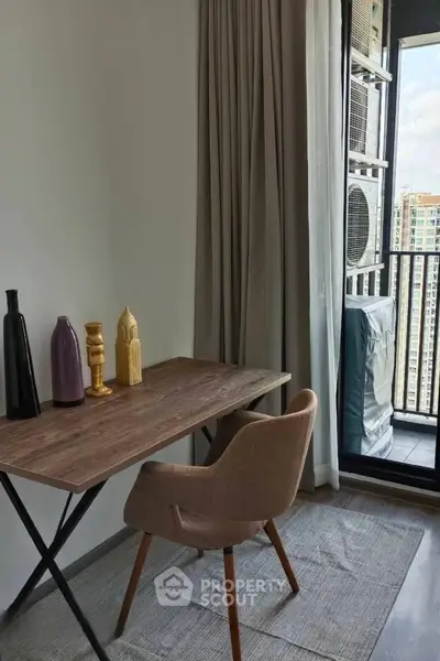 Modern study area with wooden desk and chair, adjacent to a balcony with city view.