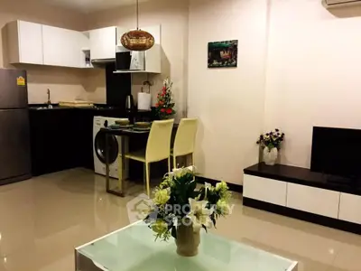 Modern open-layout kitchen and living area with stylish decor and appliances.