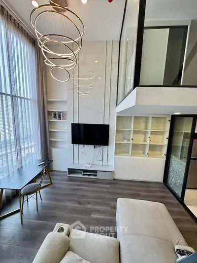 Modern living room with high ceilings, elegant lighting, and stylish furniture in a luxury apartment.