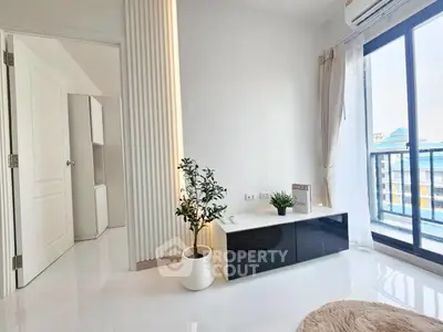 Bright modern living room with balcony access and sleek decor