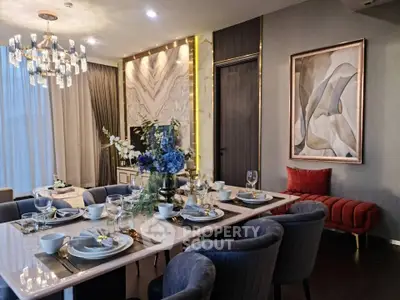 Luxurious dining room with elegant decor and modern chandelier in upscale apartment.