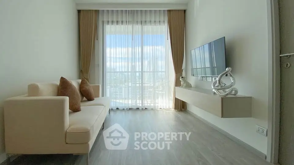 Modern living room with elegant decor and stunning city view through large windows.