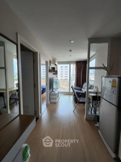 Modern apartment interior with open layout, featuring a cozy living area and stylish kitchen.