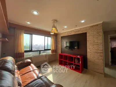 Spacious living room with city view, leather sofa, and modern decor.