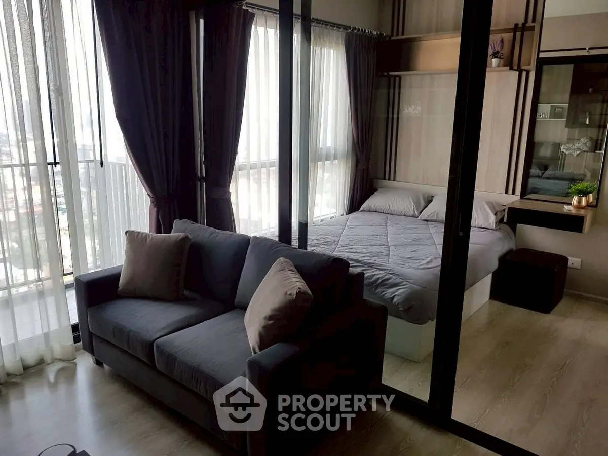Modern studio apartment with glass partition and cozy furnishings