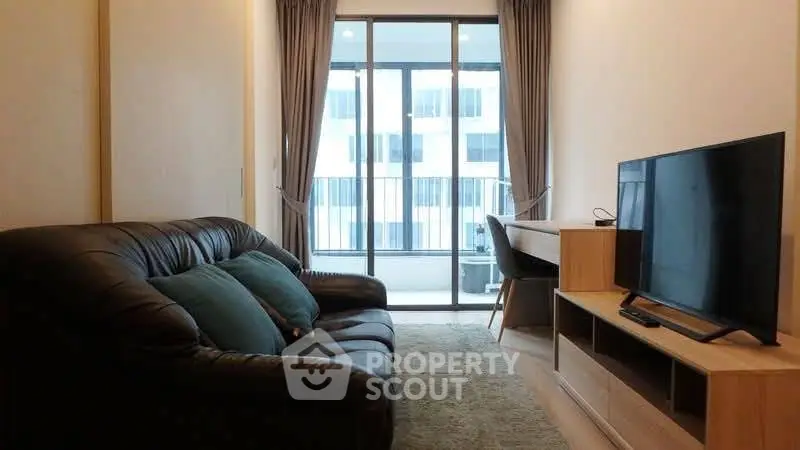 Modern living room with leather sofa and large window view