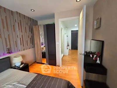 Modern bedroom with stylish decor and wooden flooring